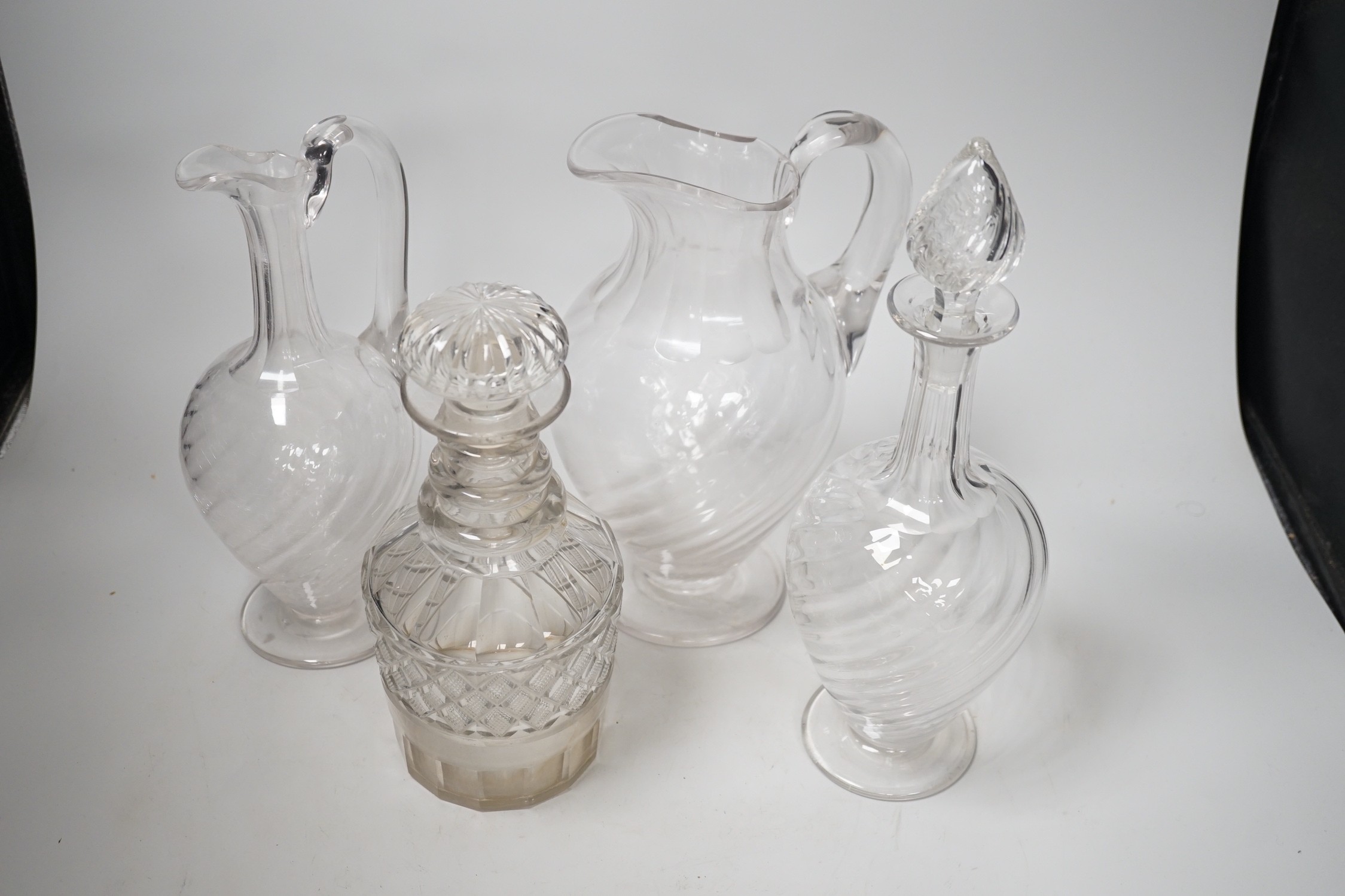 Two Victorian cut glass decanters, a ewer and a jug. Tallest 32cm